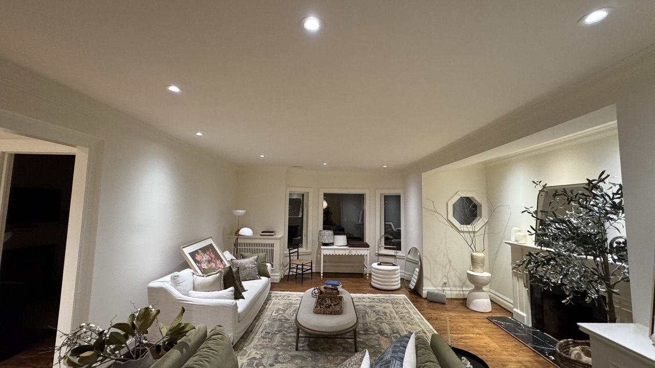 Pot lights and fireplace accent lighting installed in a Toronto living room